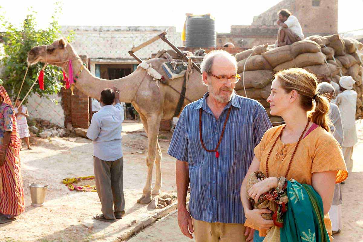 In this scene, the meeting is between Elizabeth and Richard, a key character she meets at the ashram in India. Their interaction reflects moments of introspection and emotional learning for the protagonist.